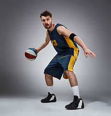 Image showing Full length portrait of a basketball player with ball 