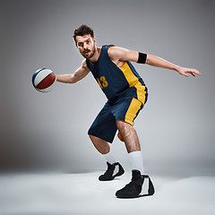 Image showing Full length portrait of a basketball player with ball 