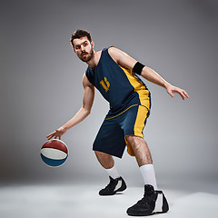 Image showing Full length portrait of a basketball player with ball 