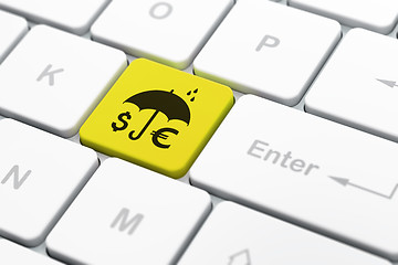 Image showing Security concept: Money And Umbrella on computer keyboard background