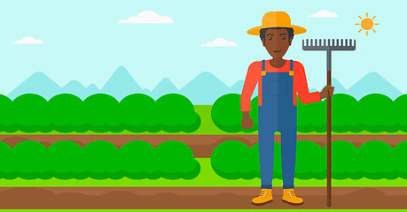 Image showing Farmer with rake.