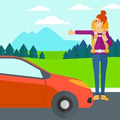 Image showing Young woman hitchhiking.