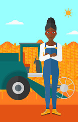 Image showing Woman standing with combine on background.