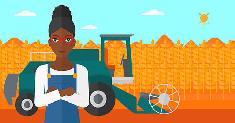 Image showing Woman standing with combine on background.