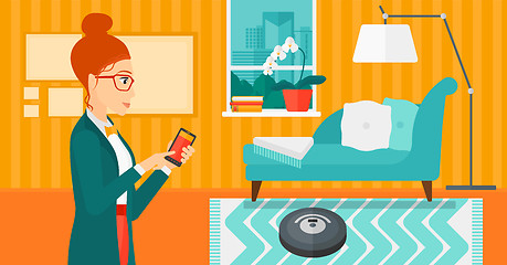 Image showing Woman with robot vacuum cleaner.