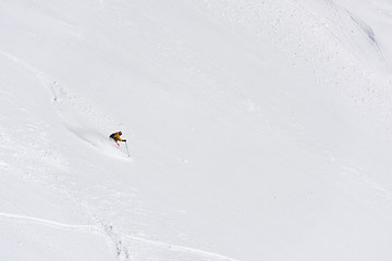 Image showing freeride skier skiing in deep powder snow