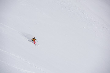 Image showing freeride skier skiing in deep powder snow