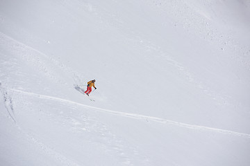 Image showing freeride skier skiing in deep powder snow