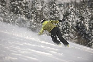 Image showing snowboarder woman enjoy freeride on fresh powder snow