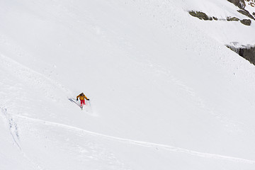 Image showing freeride skier skiing in deep powder snow