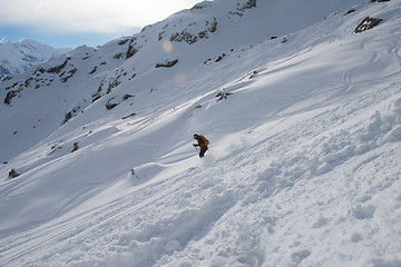 Image showing freeride skier skiing in deep powder snow