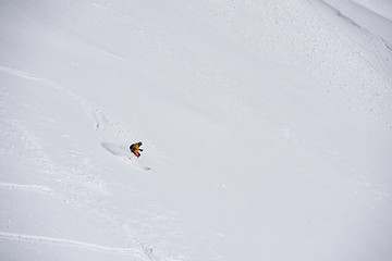 Image showing freeride skier skiing in deep powder snow