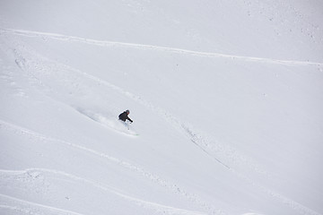 Image showing freeride skier skiing in deep powder snow