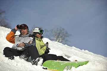 Image showing snowboarders couple relaxing