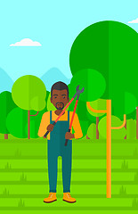 Image showing Farmer with pruner in garden.