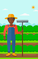 Image showing Farmer with rake.