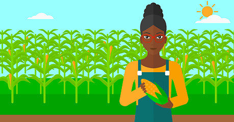 Image showing Farmer holding corn.