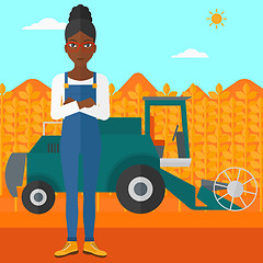 Image showing Woman standing with combine on background.
