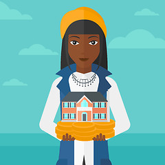 Image showing Woman holding house model.