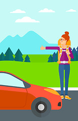 Image showing Young woman hitchhiking.