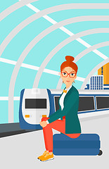 Image showing Woman sitting on railway platform.