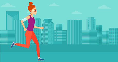 Image showing Woman jogging with earphones and smartphone.