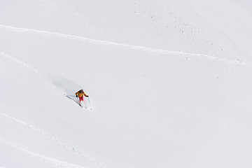 Image showing freeride skier skiing in deep powder snow