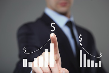 Image showing Businessman Touching a Graph Indicating Growth. dollar sign 