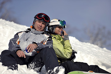 Image showing snowboarders couple relaxing