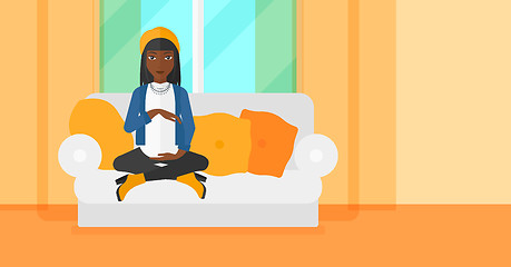 Image showing Pregnant woman sitting on sofa.