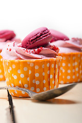 Image showing pink berry cream cupcake with macaroon on top