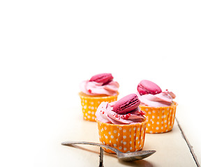 Image showing pink berry cream cupcake with macaroon on top