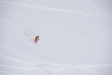 Image showing freeride skier skiing in deep powder snow