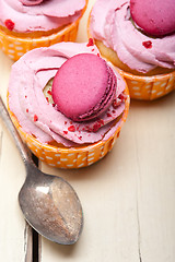 Image showing pink berry cream cupcake with macaroon on top