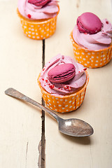 Image showing pink berry cream cupcake with macaroon on top