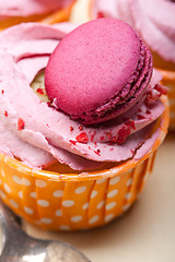 Image showing pink berry cream cupcake with macaroon on top