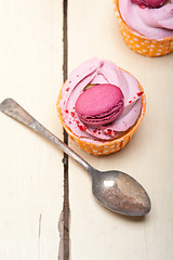 Image showing pink berry cream cupcake with macaroon on top