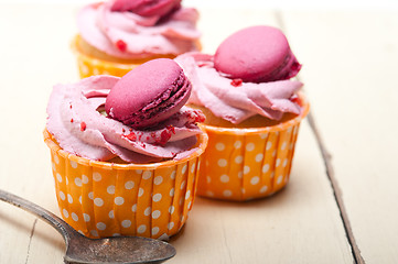 Image showing pink berry cream cupcake with macaroon on top