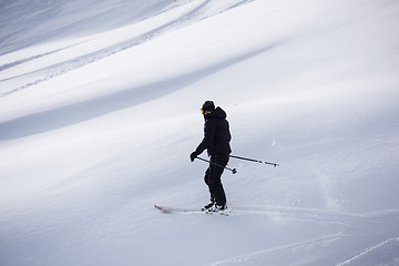 Image showing freeride skier skiing in deep powder snow