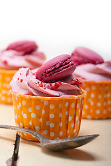 Image showing pink berry cream cupcake with macaroon on top