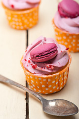 Image showing pink berry cream cupcake with macaroon on top