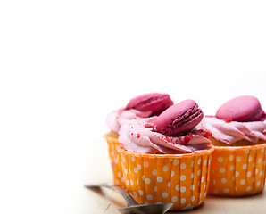 Image showing pink berry cream cupcake with macaroon on top