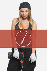 Image showing sexy female holding a cordless screwdriver. Repair icon in the background woman.