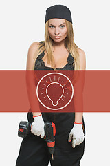 Image showing sexy female holding a cordless screwdriver. Repair icon in the background woman.