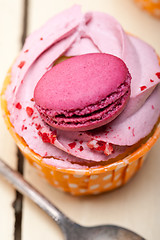 Image showing pink berry cream cupcake with macaroon on top