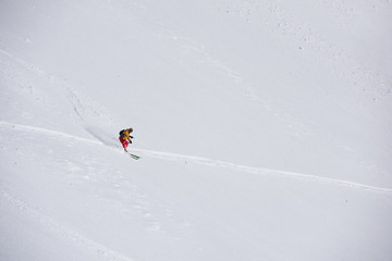 Image showing freeride skier skiing in deep powder snow