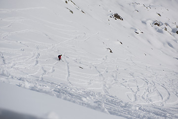 Image showing freeride skier skiing in deep powder snow