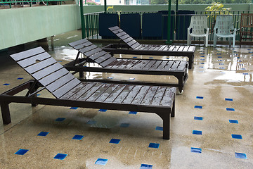 Image showing sunbeds after rain