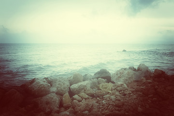 Image showing Sea and rocky coast in misty glow