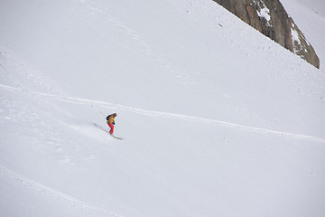 Image showing freeride skier skiing in deep powder snow